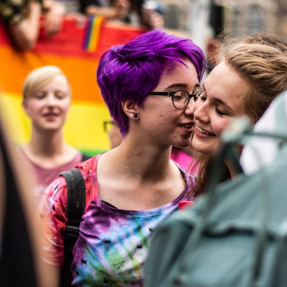 Two women kissing at a Pride parade