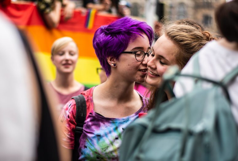 Two women kissing at a Pride parade