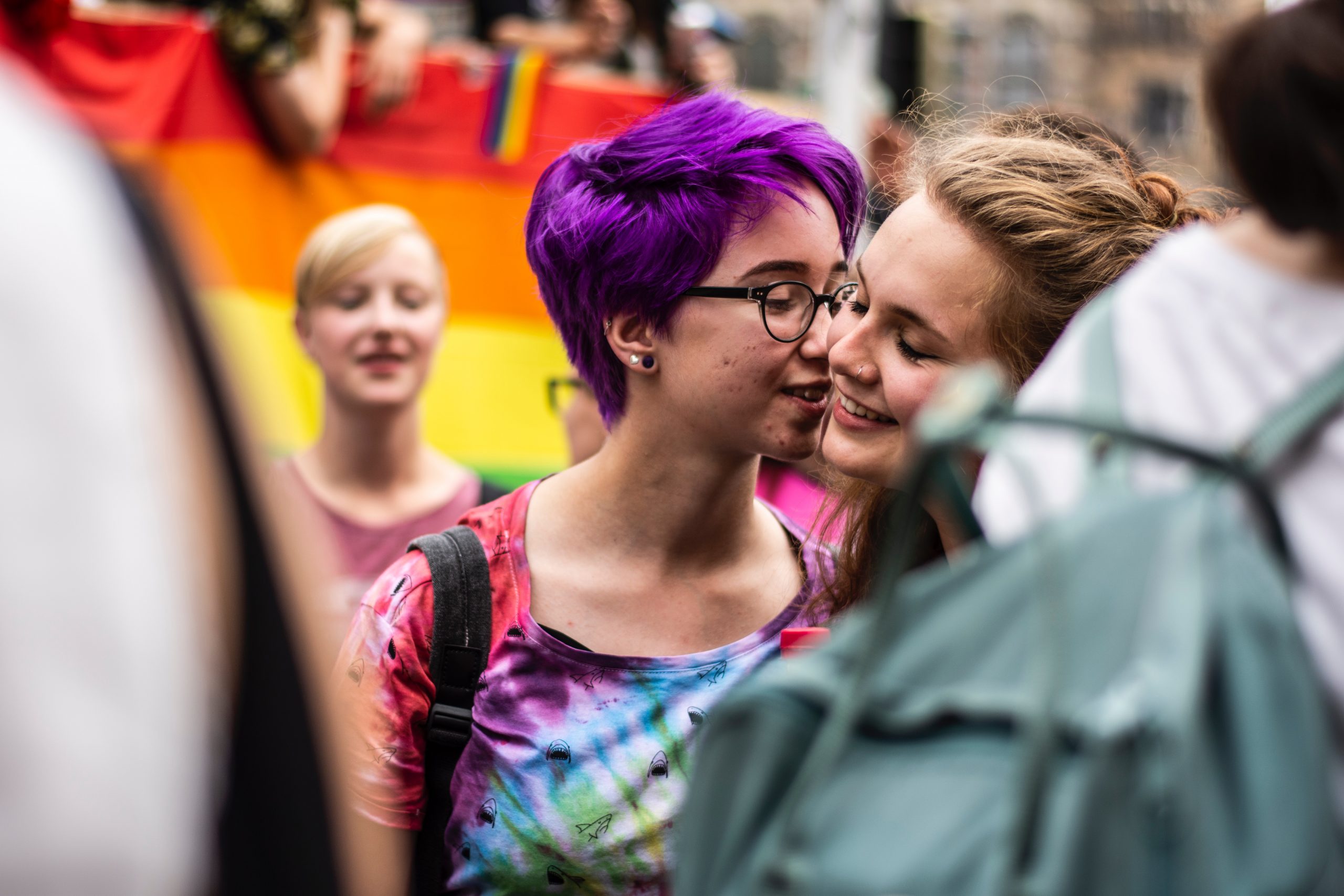 Two women kissing at a Pride parade