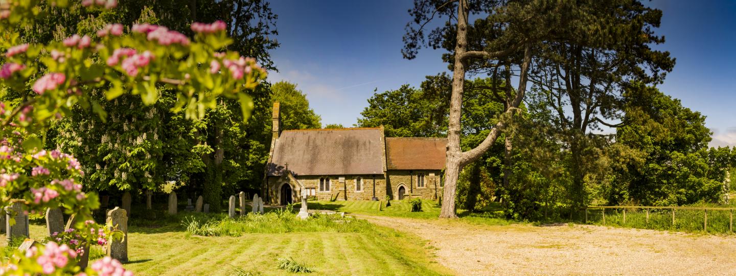 A church set among trees on a sunny day