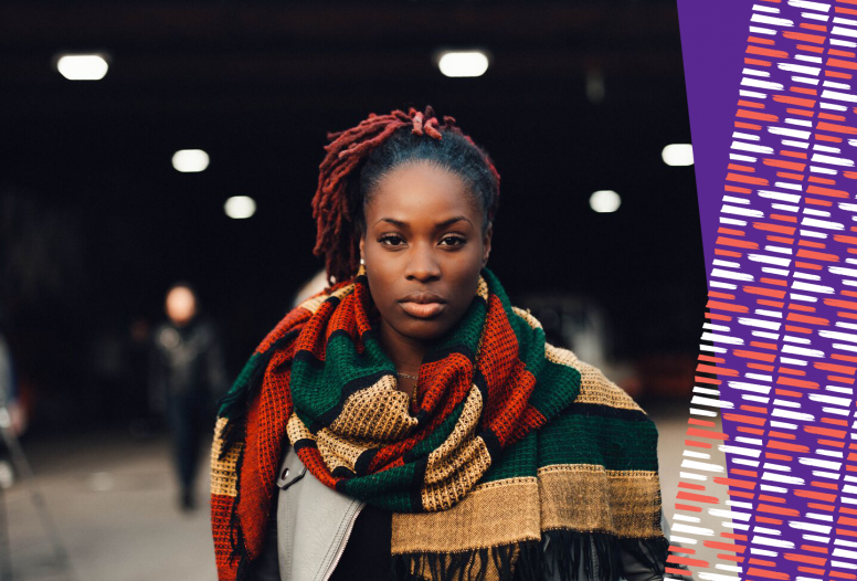 A powerful black women wearing a scarf staring at the camera