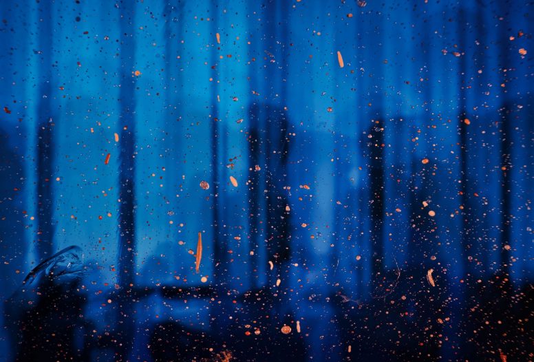 Abstract blue reflections with orange splatters