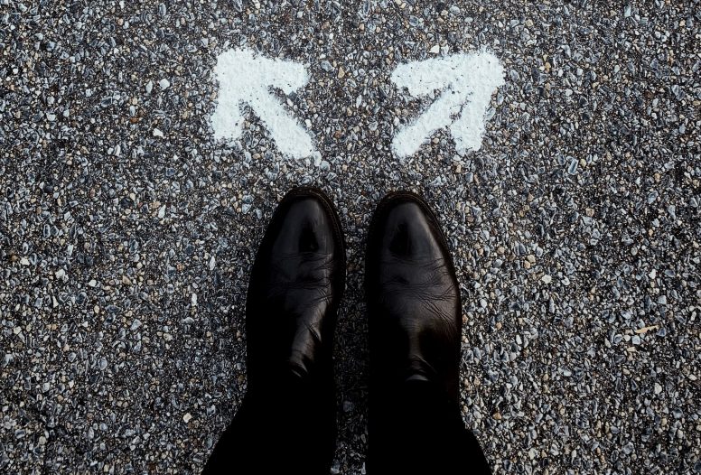 Man's shoes with two arrows pointing in opposite directions