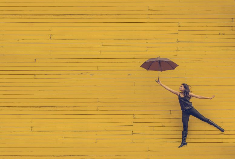 Woman flying up using an umbrella