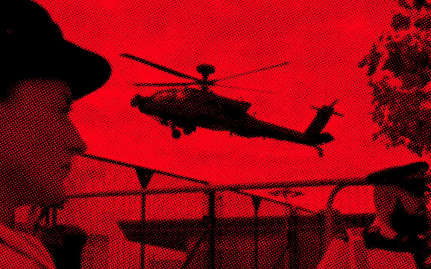 Red and black image of a military helicopter taking off with police in foreground
