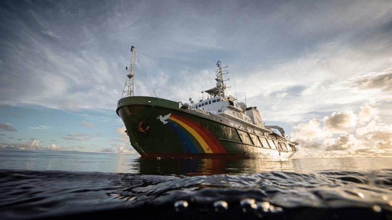 Greenpeace ship at sunset