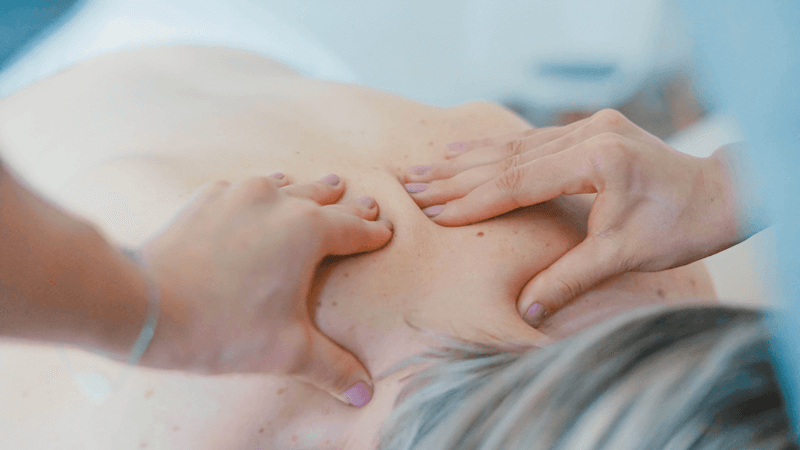 Close up of a woman massaging a client's back