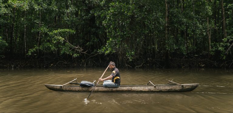 Rower in a river in Papua New Guinea