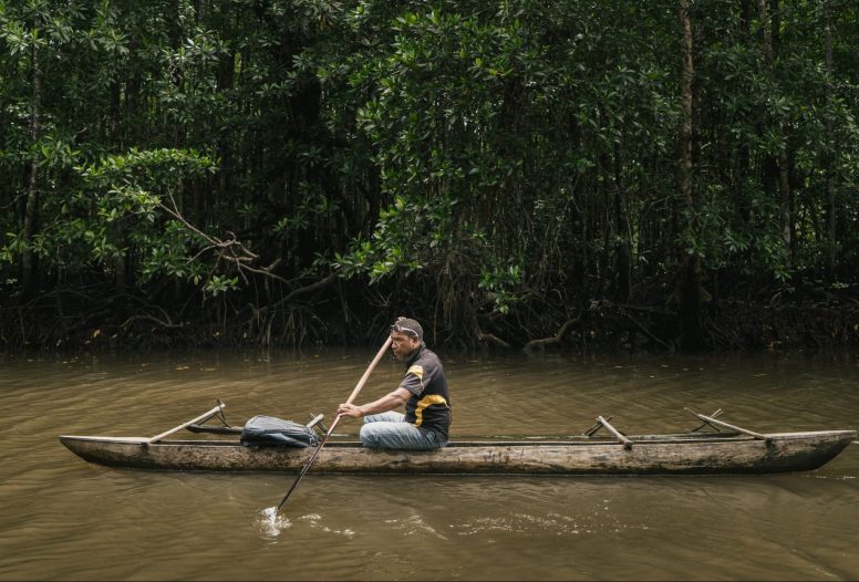 Rower in a river in Papua New Guinea