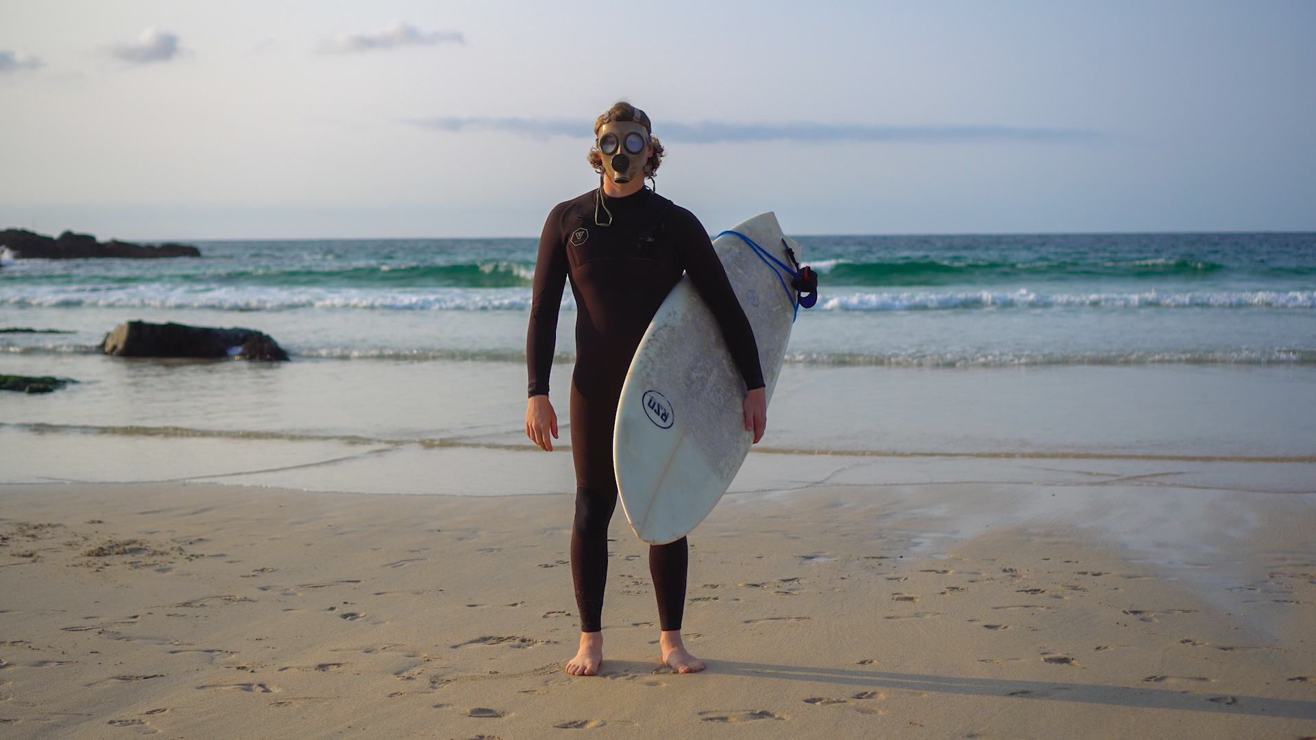 Surfer with a gas mask on
